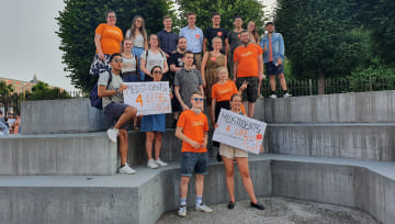 A group of ProLife Europe members posed standing on concrete forms and holding protest signs