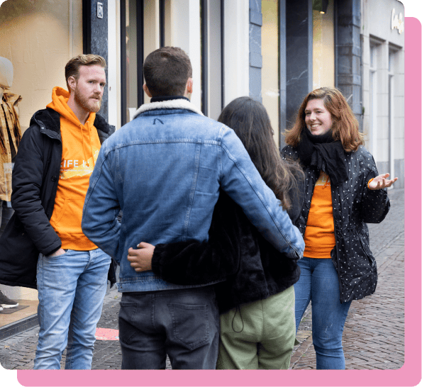 Two ProLife Europe members engage in dialog with a couple in the street