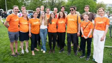 A group of ProLife Europe members standing in a line together, all wearing orange "Life is Life" t-shirts